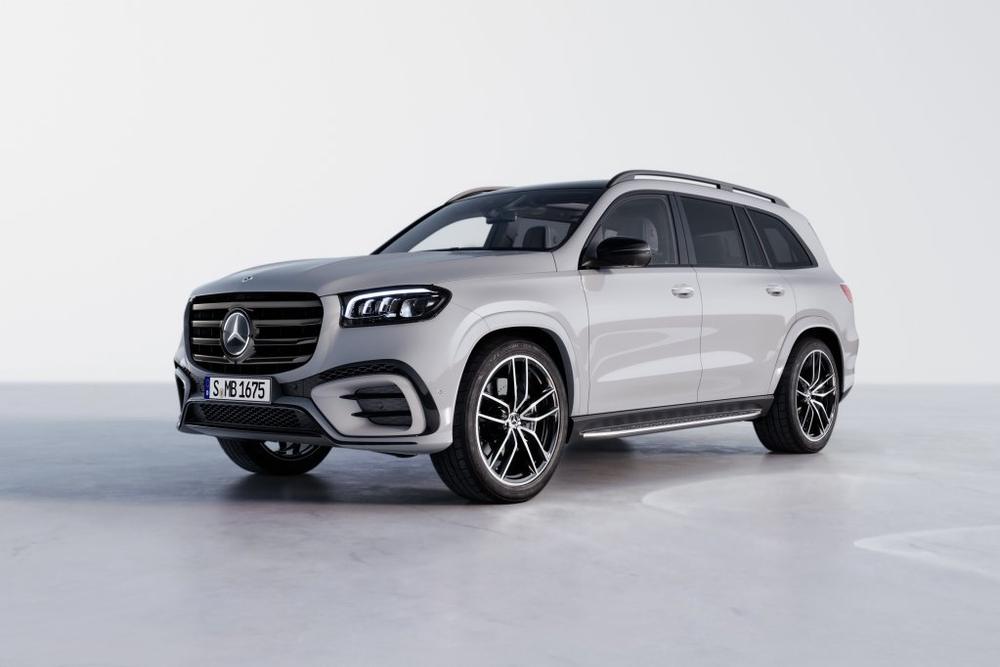 A light grey Mercedes-Benz GLS in a bright studio