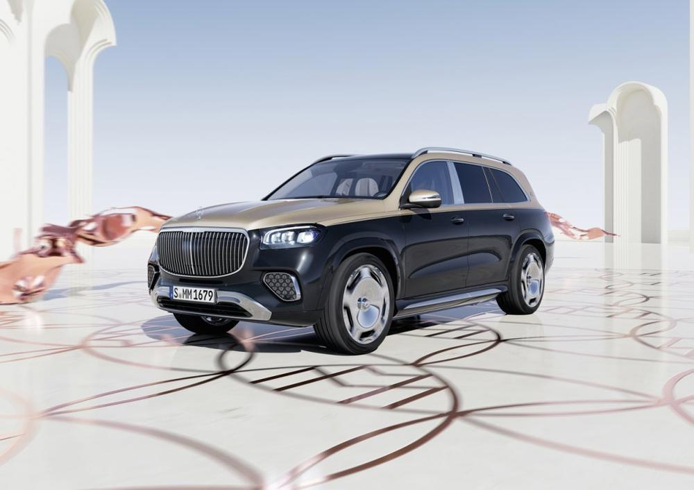 A black and gold two-tone Mercedes-Maybach GLS with a vertical-slat grille in a staged white set of arches and copper ribbons